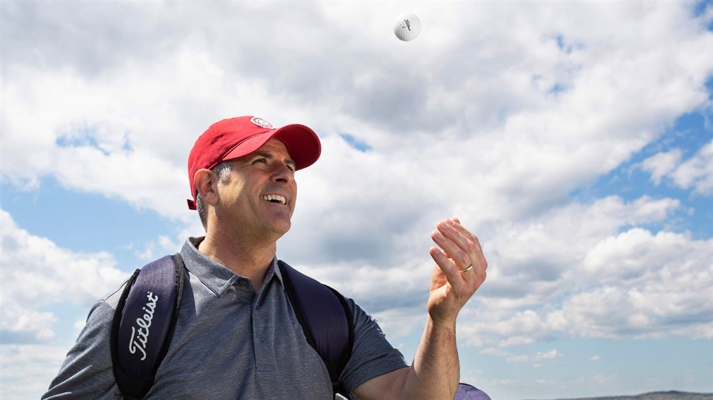 Amateur golfer tosses a new Titleist TruFeel golf ball in the air